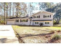 Charming two-story home featuring a painted brick facade, updated windows, and attached garage at 106 Governor Boone Ln., Georgetown, SC 29440