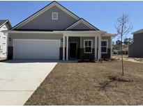 Charming single-Gathering home with a two-car garage and welcoming front porch at 1312 Winding Creek Way, Myrtle Beach, SC 29588