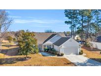 White house with gray roof, two car garage, and manicured lawn at 1377 Southwood Dr., Myrtle Beach, SC 29575