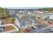 Aerial view of a townhome community with swimming pool, parking and green spaces at 1881 Colony Dr. # 7D, Surfside Beach, SC 29575