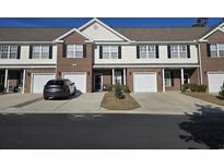 Brick front of townhome with 2-car garage and landscaping at 270 Connemara Dr. # C, Myrtle Beach, SC 29579