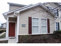 Tan colored siding two story home with red door and brown shutters at 306 Kiskadee Loop # A, Conway, SC 29527