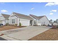 Gray siding two-story house with white garage door and landscaping at 4040 Taranto Loop # D, Myrtle Beach, SC 29579