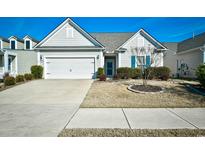 Craftsman style home with attached garage and manicured lawn at 6425 Cascata Dr., Myrtle Beach, SC 29572