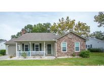 Brick ranch home with front porch and landscaped lawn at 654 Blue Bird Ln., Murrells Inlet, SC 29576