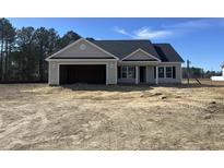 Charming single story home with neutral colored siding, black shutters and an attached two car garage at 8183 Kerl Rd., Conway, SC 29526