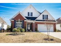 Brick front house with a two-car garage and manicured lawn at 1055 University Forest Dr., Conway, SC 29526