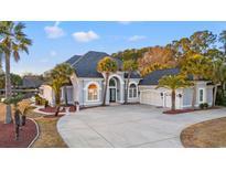 Luxury home with a large driveway and mature landscaping at 117 Ashley River Rd., Myrtle Beach, SC 29588