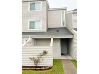 Two-story condo building with light beige siding and a walkway at 1650 Deercreek Rd., Surfside Beach, SC 29575