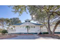 Exterior of charming house with gray siding, and landscaping at 19 Cattail Ct. # 2B, Pawleys Island, SC 29585