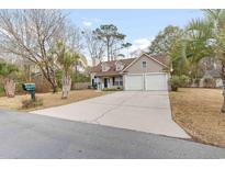 Two-story house with a two-car garage and landscaping at 320 Muirfield Rd., Myrtle Beach, SC 29588