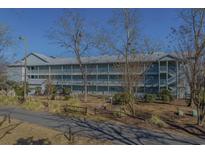 Exterior view of a three-story building with balconies and landscaping at 5905 South Kings Hwy. # 4205, Myrtle Beach, SC 29575