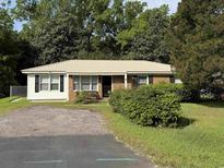 Charming single-story home with a metal roof, brick accents, and well-maintained landscaping at 10 Buckthorn St., Andrews, SC 29510