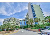 Exterior view of Coral Beach Resort, showcasing its architecture and landscaping at 1105 S Ocean Blvd. # 516, Myrtle Beach, SC 29577