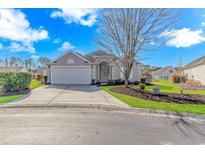 Attractive one-story home with a landscaped yard and attached garage at 113 Barn Owl Ct., Carolina Shores, NC 28467