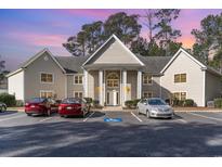 Beige building exterior with columns and ample parking at 1350 Mcmaster Dr. # C, Myrtle Beach, SC 29575