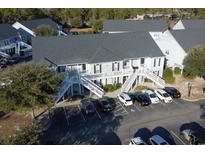 Aerial view of a two-story building with parking and surrounding landscape at 149 Westhaven Dr. # B13, Myrtle Beach, SC 29579