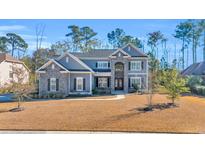 Two-story house with gray siding, stone accents, and a landscaped lawn at 2560 Ellerbe Circle, Myrtle Beach, SC 29588