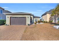 Attractive one-story home with a brown garage door and landscaped yard at 274 Avenue Of The Palms, Myrtle Beach, SC 29579