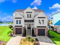 Two-story home with white siding, brick accents, and a two-car garage at 304 Spartina Ct., North Myrtle Beach, SC 29582