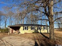 Ranch style home with mature trees and a large yard at 3757 Methodist Rehobeth Rd., Galivants Ferry, SC 29544