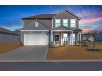 Two-story house with gray siding, white trim, and a two-car garage at 5023 Sweet Birch Lane, Conway, SC 29526