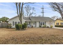 Charming one-story house with gray siding, landscaped lawn, and attached garage at 603 Plantation Dr., Surfside Beach, SC 29575