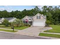 Charming one-story house with a two-car garage and landscaped lawn at 648 Twinflower Dr., Little River, SC 29566