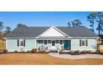 Single-story home with light teal siding, gray roof, and rocking chairs on the porch at 926 Eula Dr., Conway, SC 29526