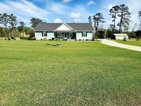 Charming home featuring a well-manicured lawn, inviting entrance and covered parking at 926 Eula Dr., Conway, SC 29526