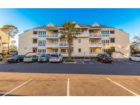 A spacious three-story condo building offering convenient parking at 1100 Possum Trot Rd. # H234, North Myrtle Beach, SC 29582