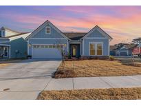 Craftsman style home with light blue siding, two-car garage, and landscaped lawn at 1204 Passante Ave., Myrtle Beach, SC 29572