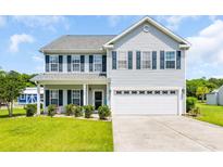 Charming two-story home featuring a well-manicured lawn, attached two car garage and welcoming front porch at 1213 Pineridge St., Conway, SC 29527