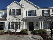 Two-story house with white siding, dark trim, and landscaping at 1266 Harvester Circle, Myrtle Beach, SC 29579