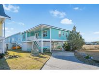 Charming light teal exterior with a spacious elevated deck at 147 Anglers Dr., Murrells Inlet, SC 29576