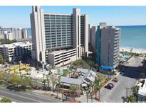 Aerial view of oceanfront resort, pool, playground, and parking at 201 74Th Ave. N # 701, Myrtle Beach, SC 29572
