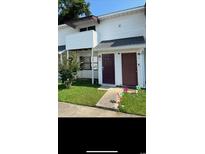 Two-story building exterior with private entrance and small lawn at 209 Cedar St. # C-4, Myrtle Beach, SC 29577