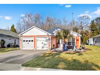 Two-car garage, paver driveway, and landscaped yard at 2305 Ameron Ct., North Myrtle Beach, SC 29582