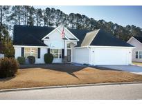 Charming one-story house with a white exterior, two-car garage, and manicured lawn at 265 Encore Circle, Myrtle Beach, SC 29579