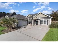 Brick house with a 2-car garage and landscaped yard at 278 Seagrass Loop, Myrtle Beach, SC 29588