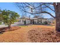 Ranch style home with mature landscaping and a spacious front yard at 304 Sanders Ct., Mullins, SC 29574
