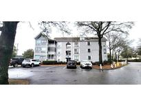 Attractive condo building featuring covered balconies and ample parking in a well-kept community at 351 Lake Arrowhead Rd. # 24-293, Myrtle Beach, SC 29572