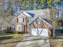 Brick two-story house with a two-car garage and landscaped yard at 394 Blackberry Ln., Myrtle Beach, SC 29579