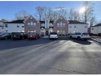 An exterior view of a two-story apartment building with brick accents and ample parking space at 4273 Santolina Way # E, Murrells Inlet, SC 29576