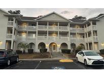 Exterior view of a two-story condo building with parking at 4430 Eastport Blvd. # L7, Little River, SC 29566