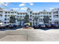 Cascade complex features multi-level condos and a sign surrounded by palm trees and parking at 4560 Greenbriar Dr. # 102-B, Little River, SC 29566