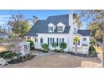 Beautiful two-story home with a charming front porch and well-manicured landscaping at 4600 Marion Circle, North Myrtle Beach, SC 29582
