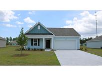Charming one-story home with light blue siding, a white garage door, and a landscaped lawn at 528 Duvall St., Longs, SC 29568