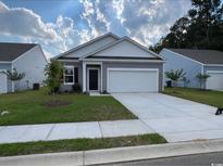 Charming one-story house with gray siding, white trim, and a two-car garage at 539 Tillage Ct., Conway, SC 29526