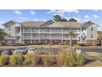 Two-story condo building with ample parking and landscaping at 5750 Oyster Catcher Dr. # 1124, North Myrtle Beach, SC 29582
